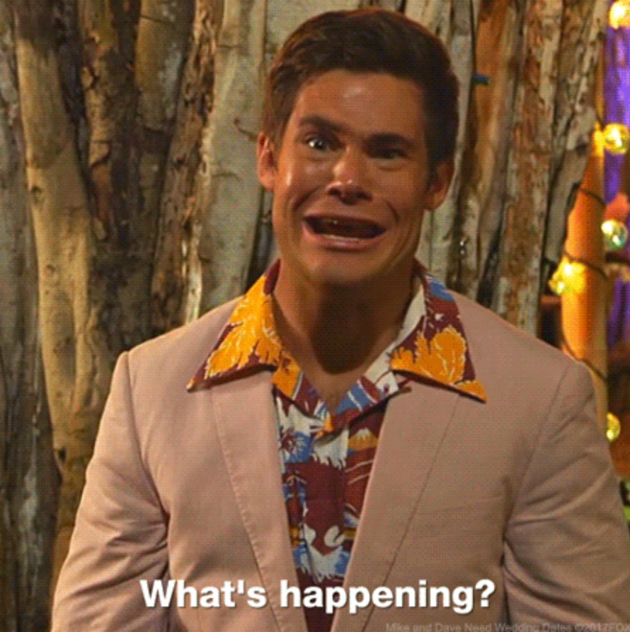 Man making a dramatic face, wearing a floral shirt under a beige jacket, stands in front of trees. Text reads, "What's happening?"