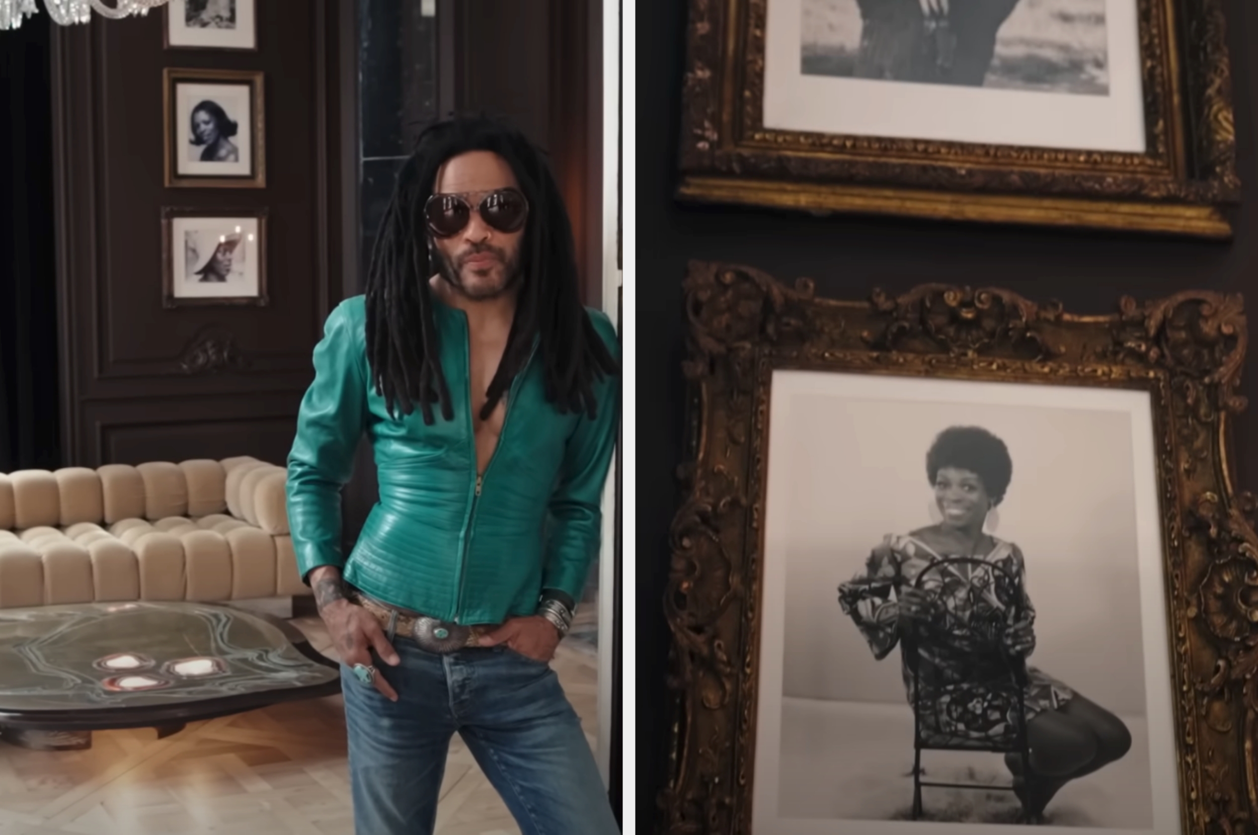 Person with long hair wearing a fitted jacket and jeans stands in a stylish room next to framed photos of historical figures