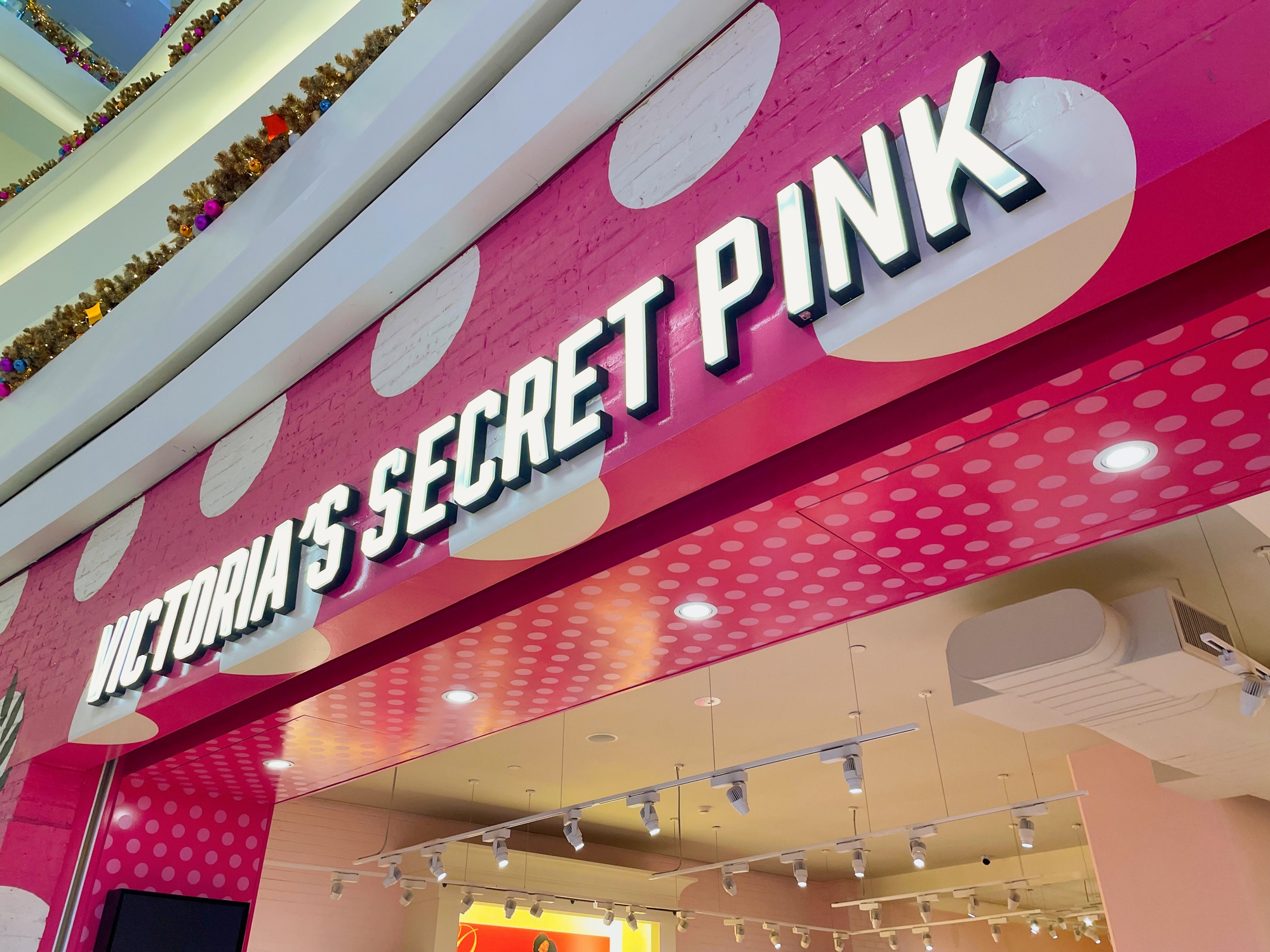 Victoria's Secret Pink storefront with polka dot decor and overhead lights