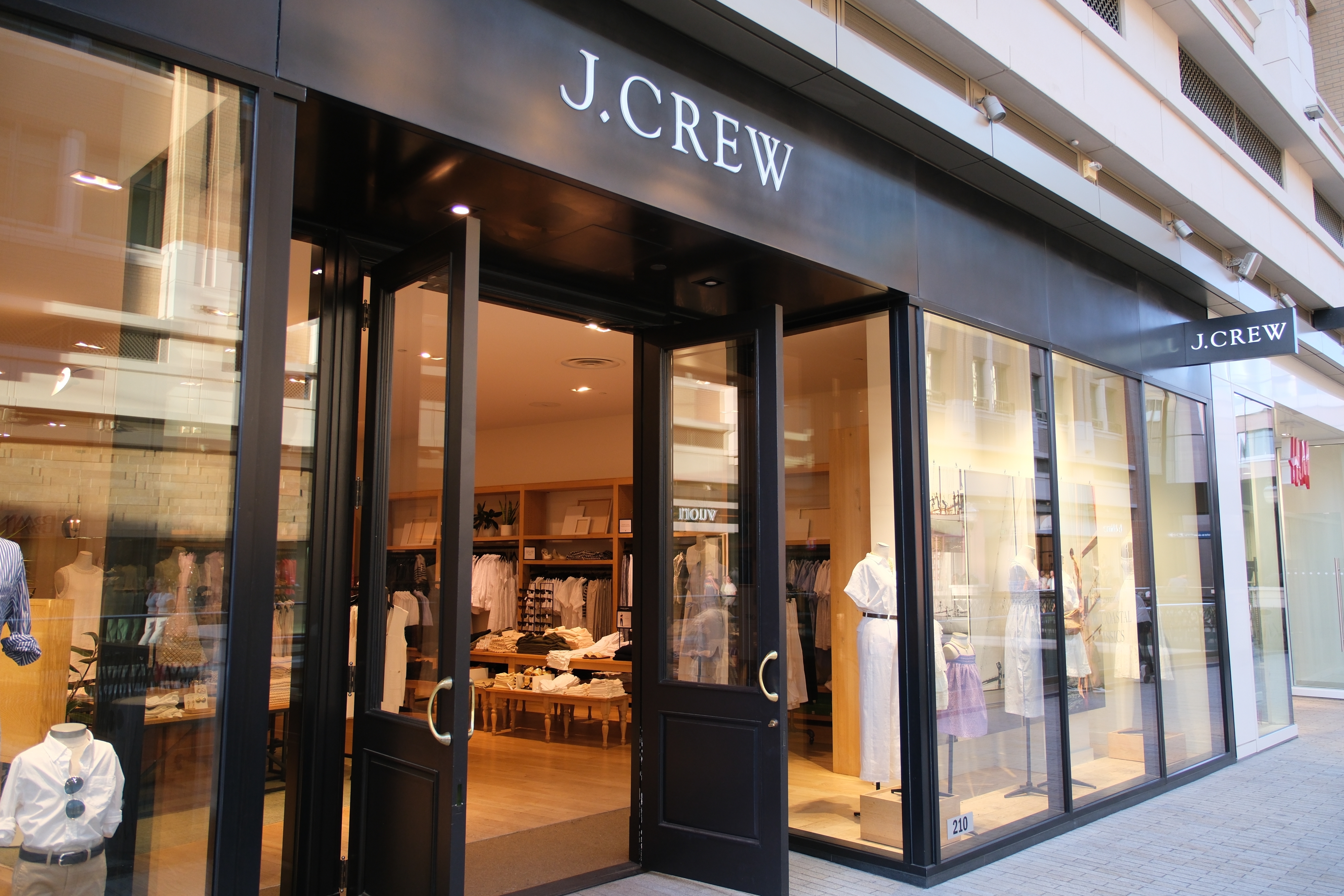 J.Crew store exterior with large windows showcasing clothing displays inside