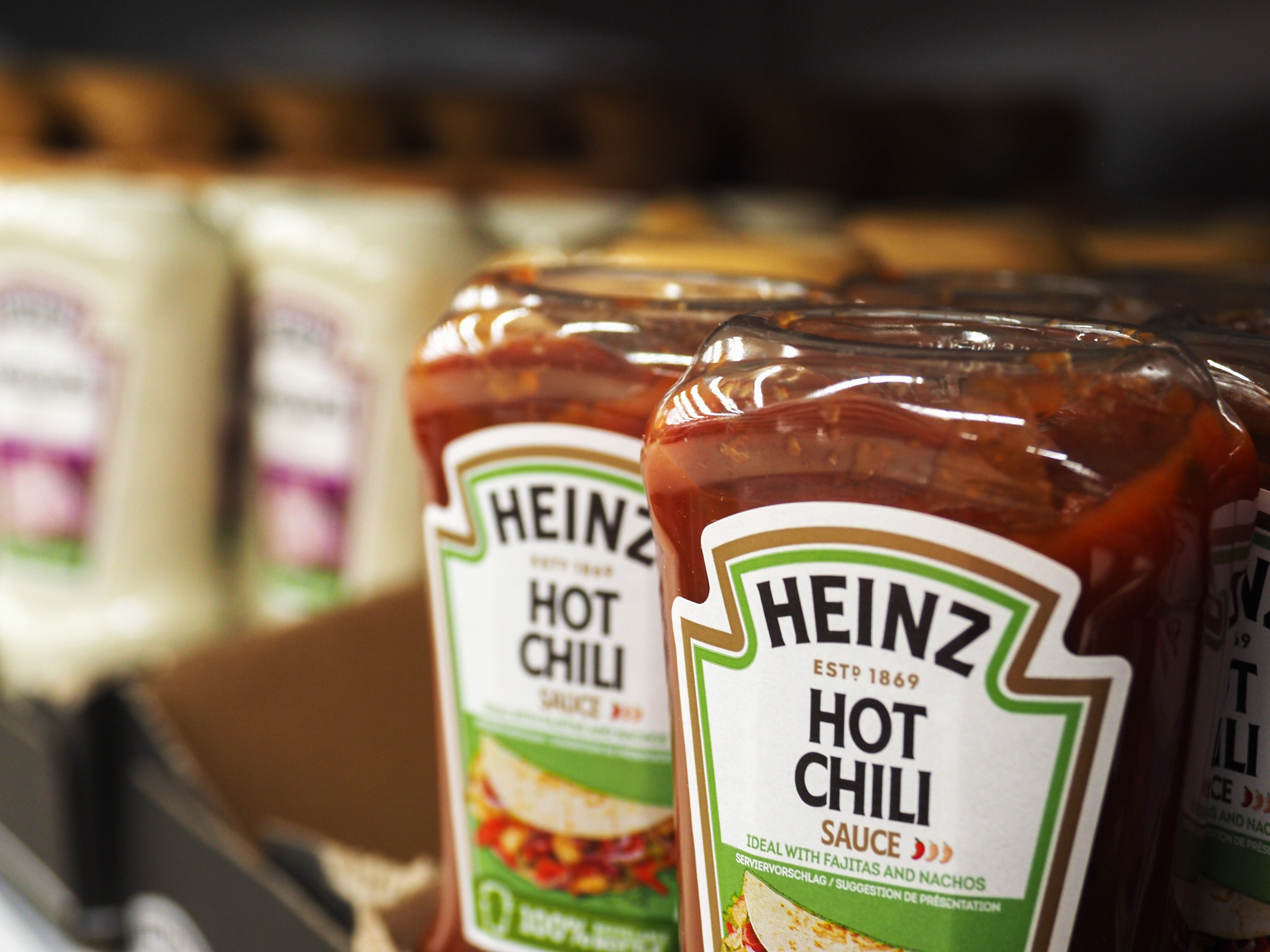 Heinz Hot Chili Sauce bottles on a store shelf, part of a food product display