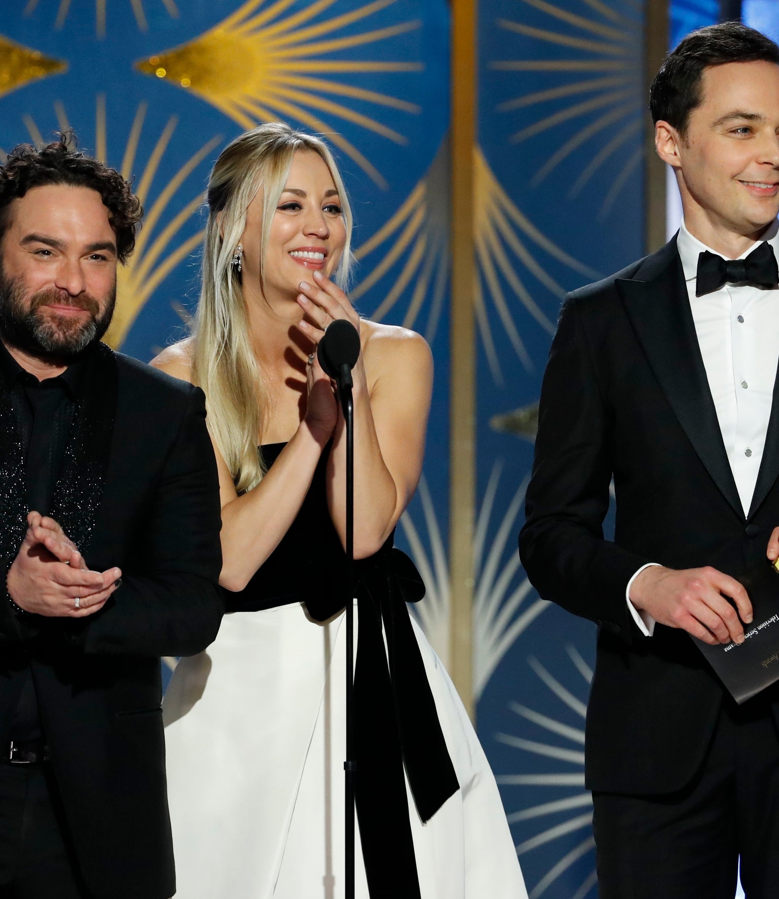 Johnny Galecki and Kaley Cuoco on stage at an award show