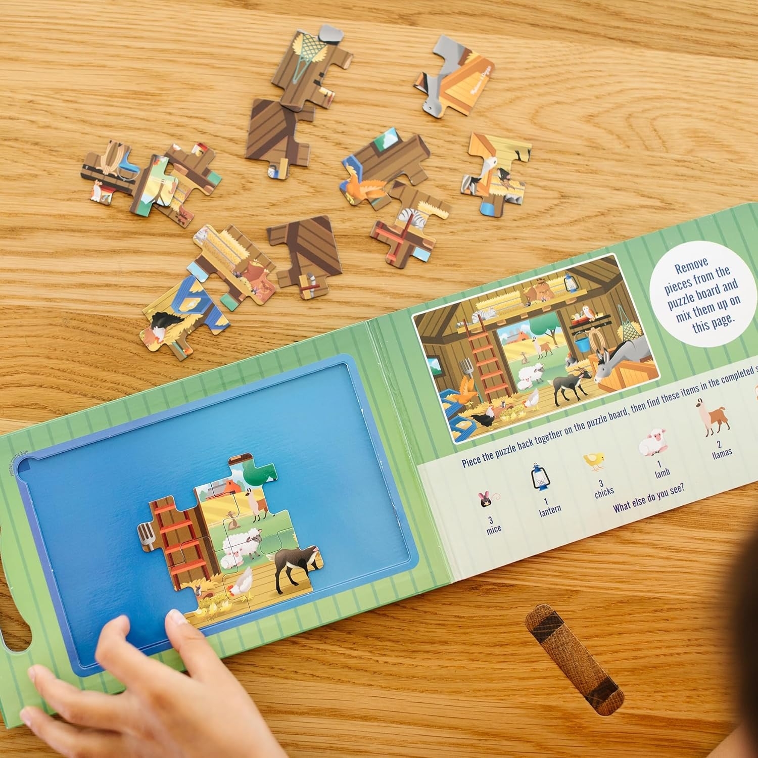 Child assembling a farm-themed wooden puzzle with various animal pieces. An instruction booklet with images guides the process on a wooden table