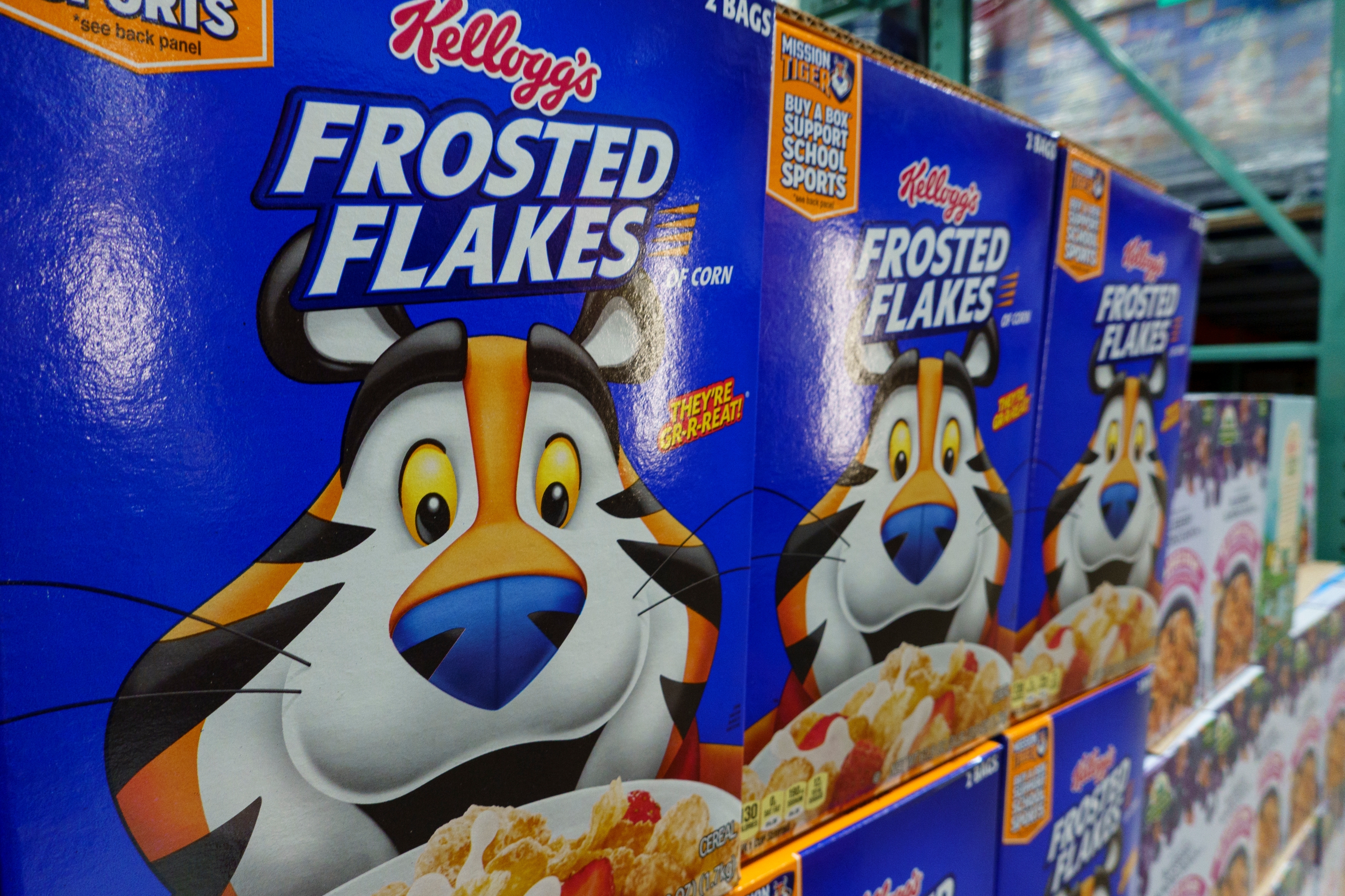 Boxes of Kellogg's Frosted Flakes featuring Tony the Tiger on a store shelf