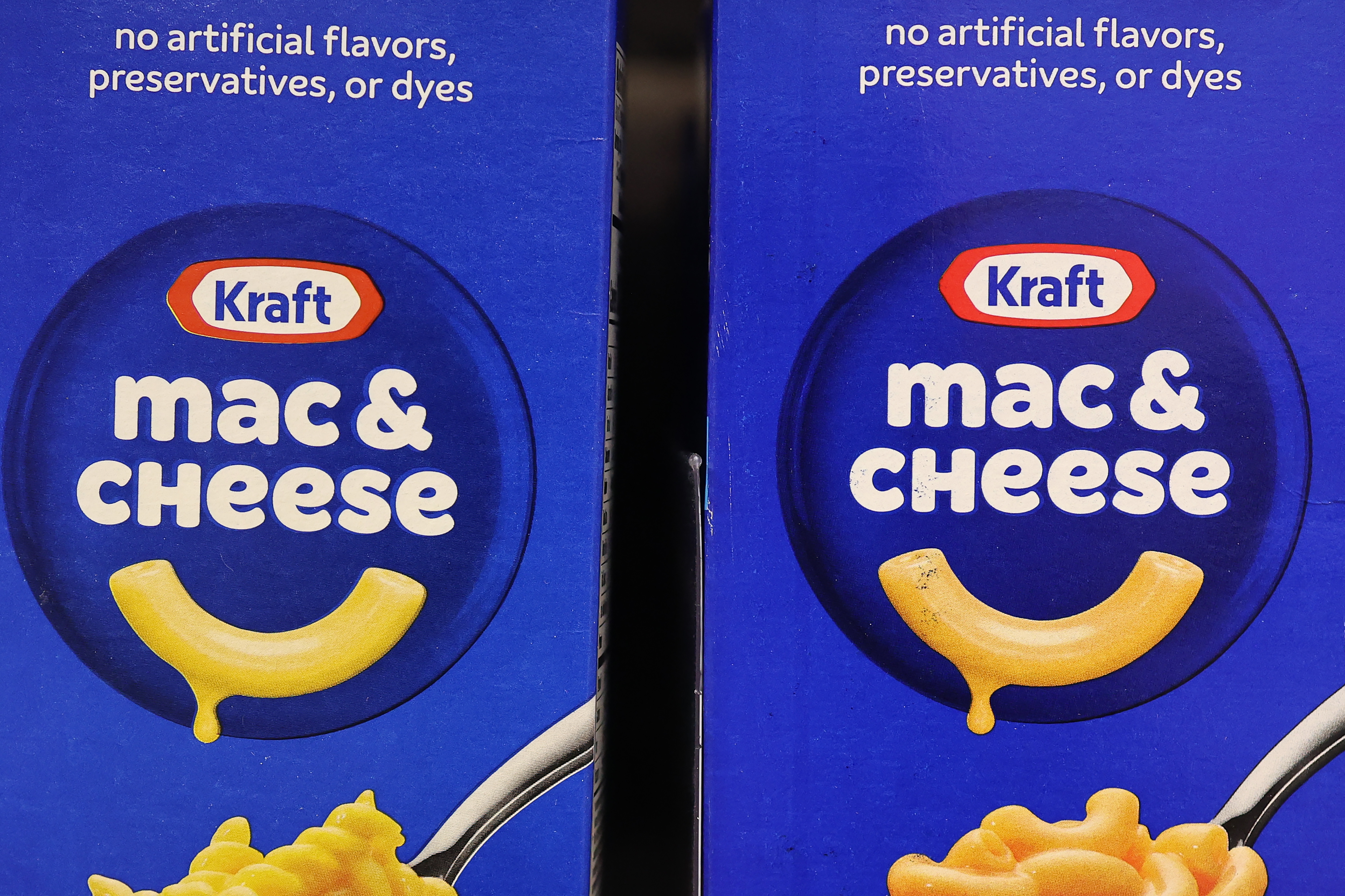 Two boxes of Kraft mac & cheese shown closely, emphasizing "no artificial flavors, preservatives, or dyes" text