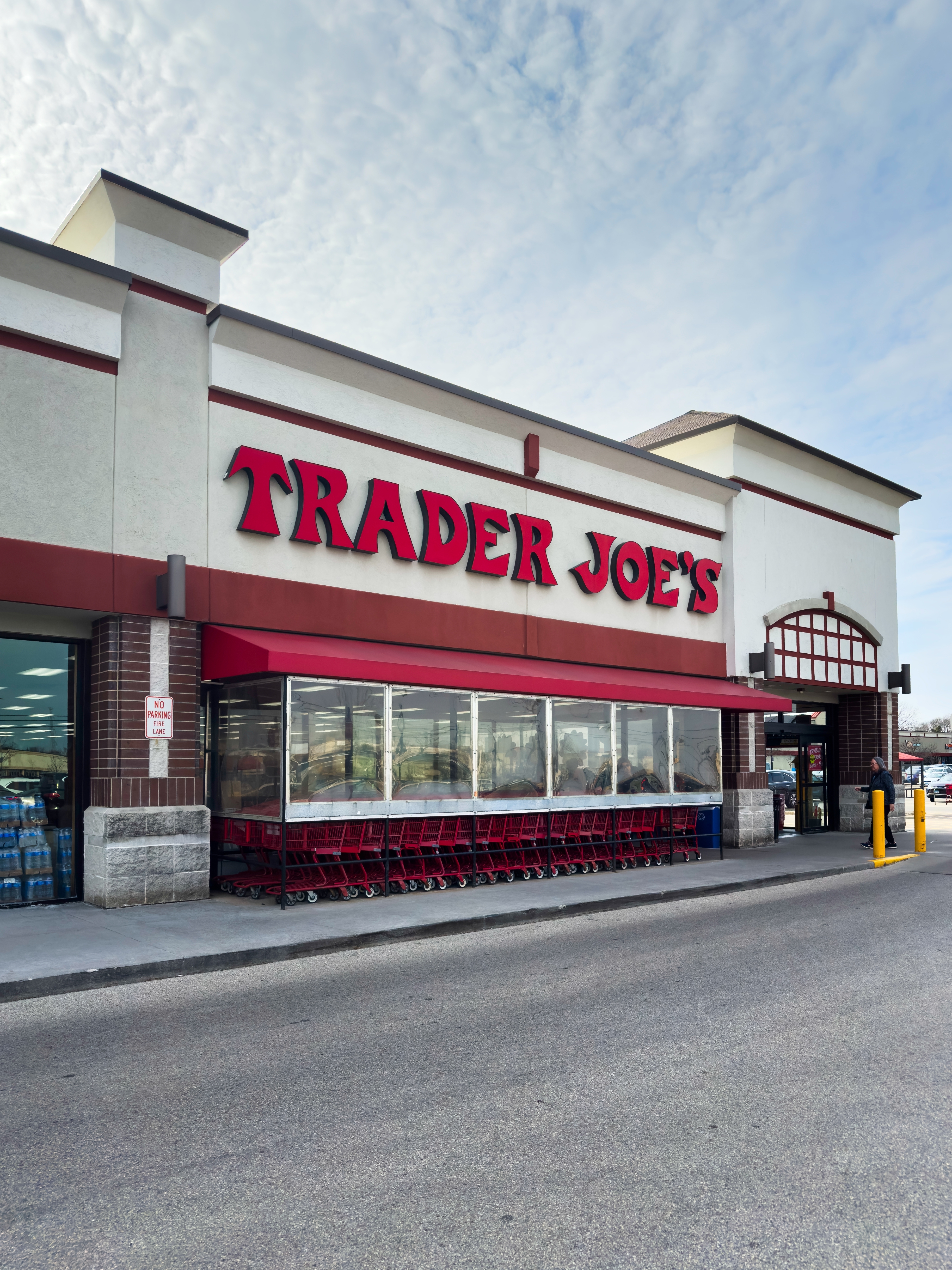 Trader Joe's storefront with shopping carts lined up outside under a covered entrance