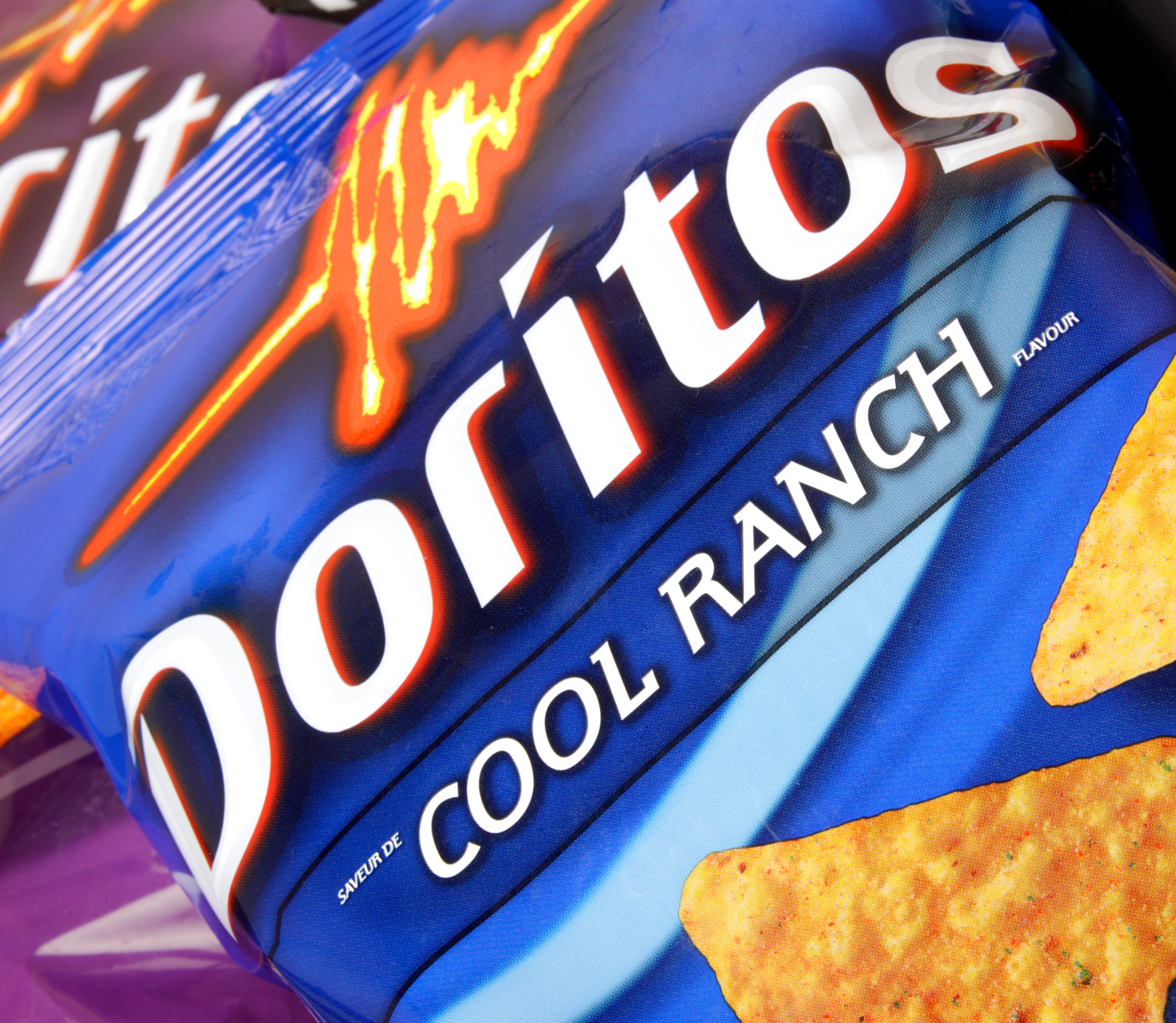 Doritos Cool Ranch chips in a blue bag, closeup shot
