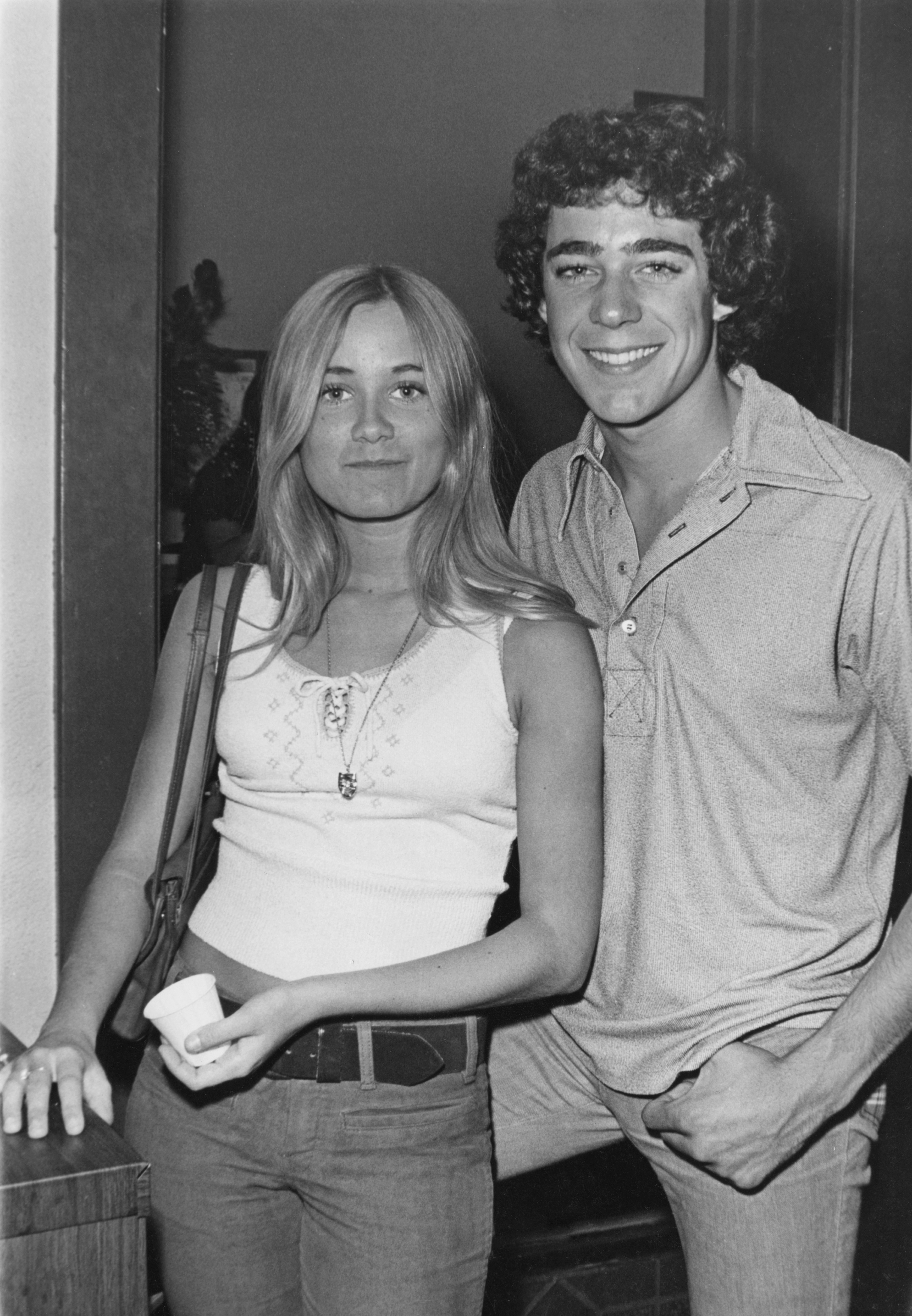 Mauren and Barry behind the scenes together and smiling at the camera