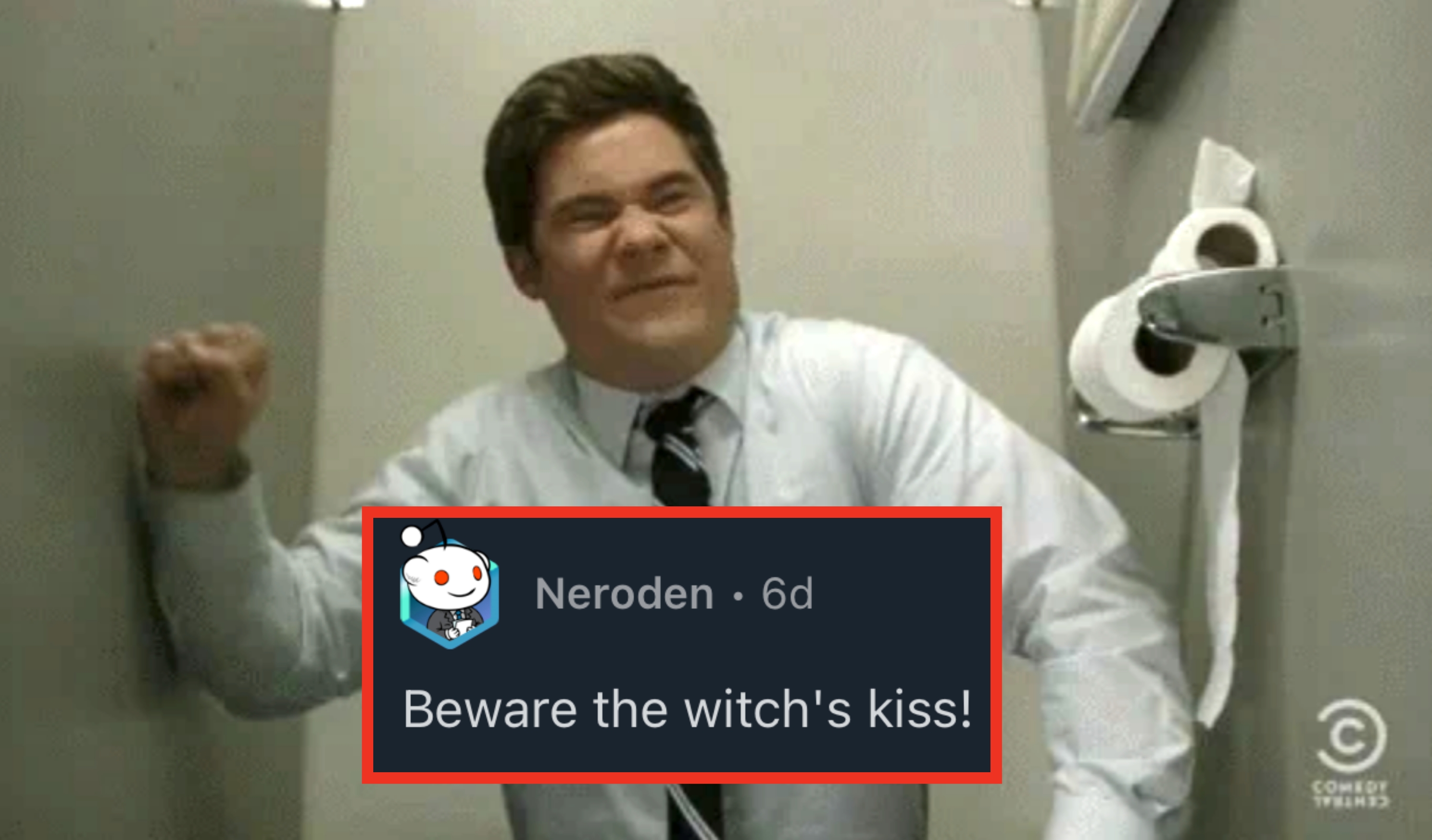 Person in a bathroom stall wearing a tie, making a strained facial expression. Toilet paper roll is visible on the side wall