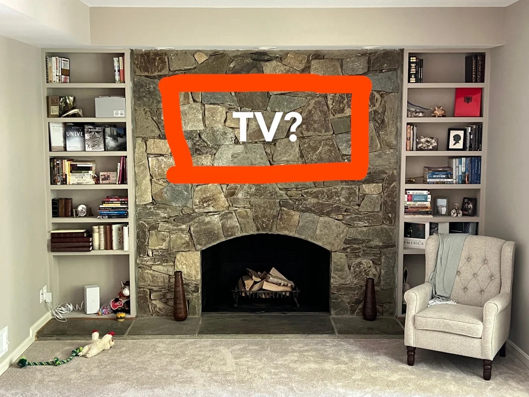 Living room with stone fireplace, bookshelves, and a chair. Red rectangle and "TV?" are drawn over the fireplace