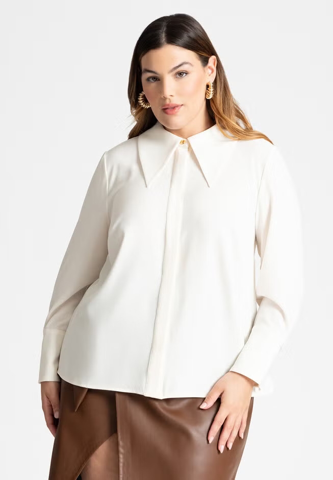 Model wearing a cream blouse with a large collar and a brown leather skirt