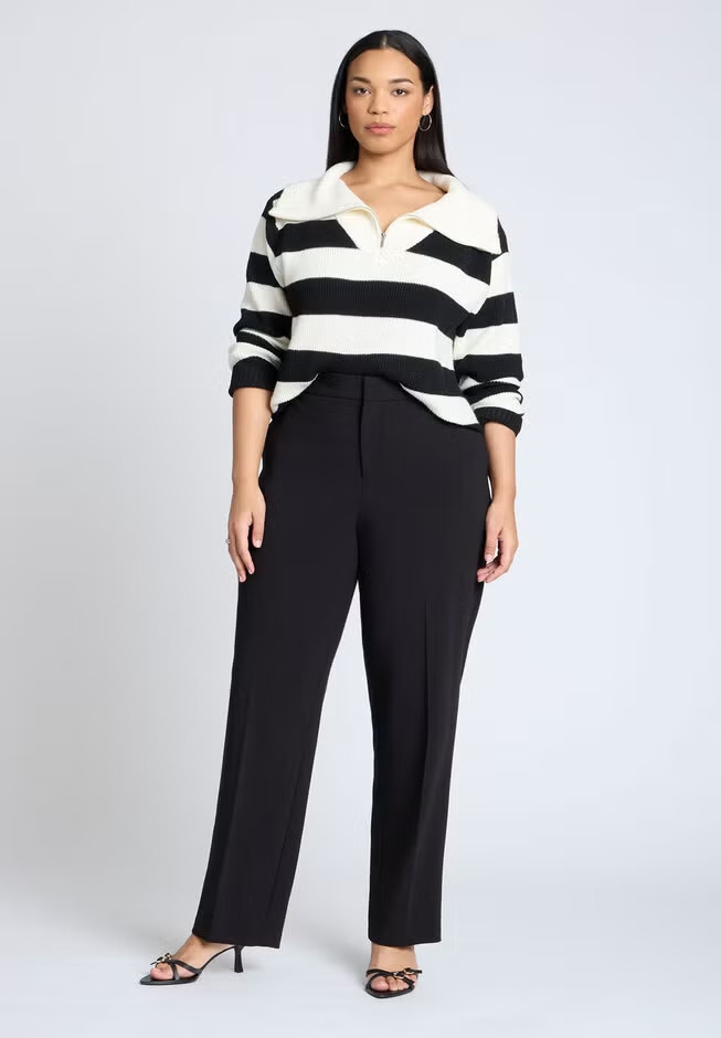 Model wearing a striped sweater with a collar and black pants, showcasing a chic, casual outfit with heeled sandals for a shopping-themed article