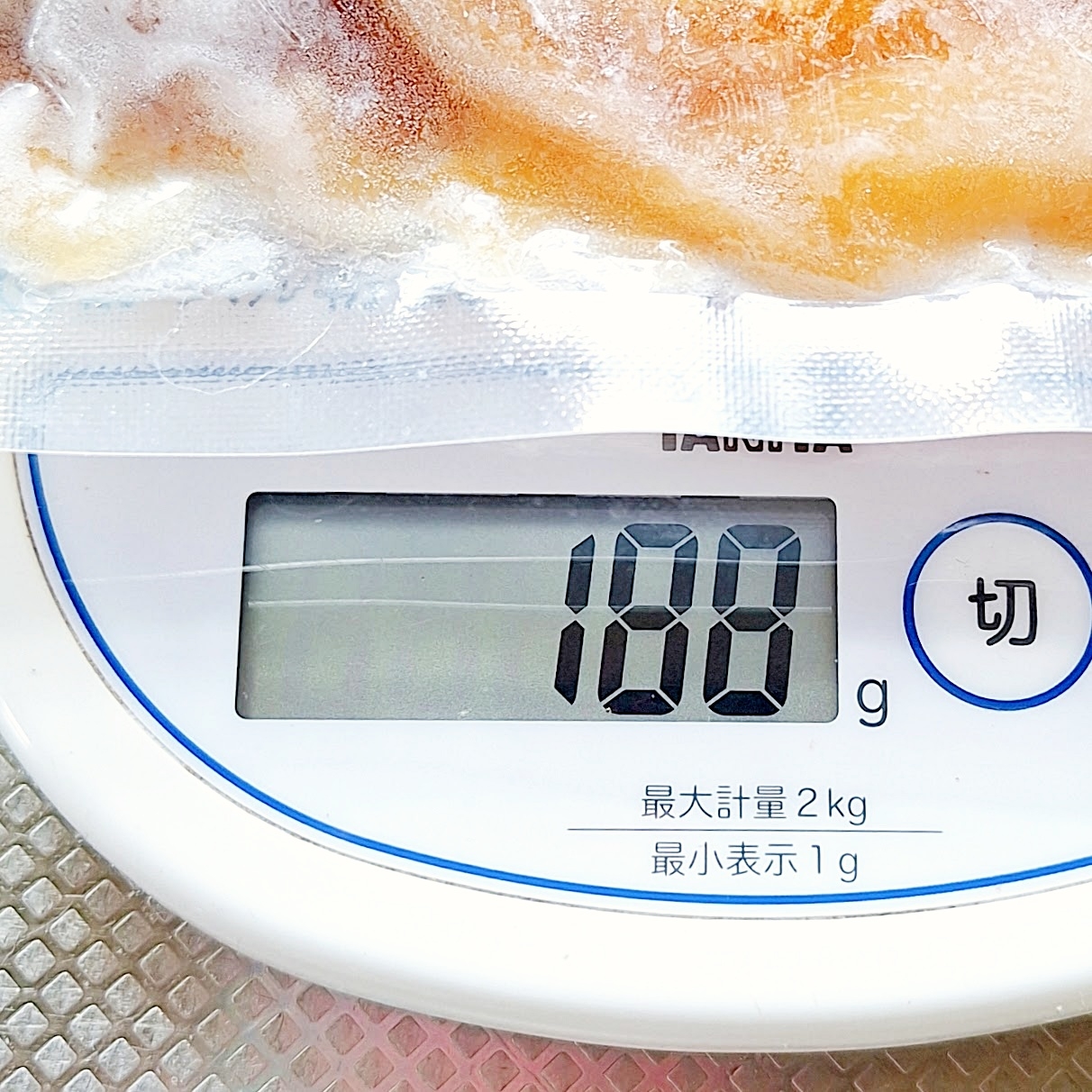 真空パックの食品がデジタルスケールに載っており、重量は188グラムを示しています。