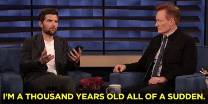 Adam Scott speaking to Conan O'Brien on the Conan talk show. Text below reads: "I'm a thousand years old all of a sudden"