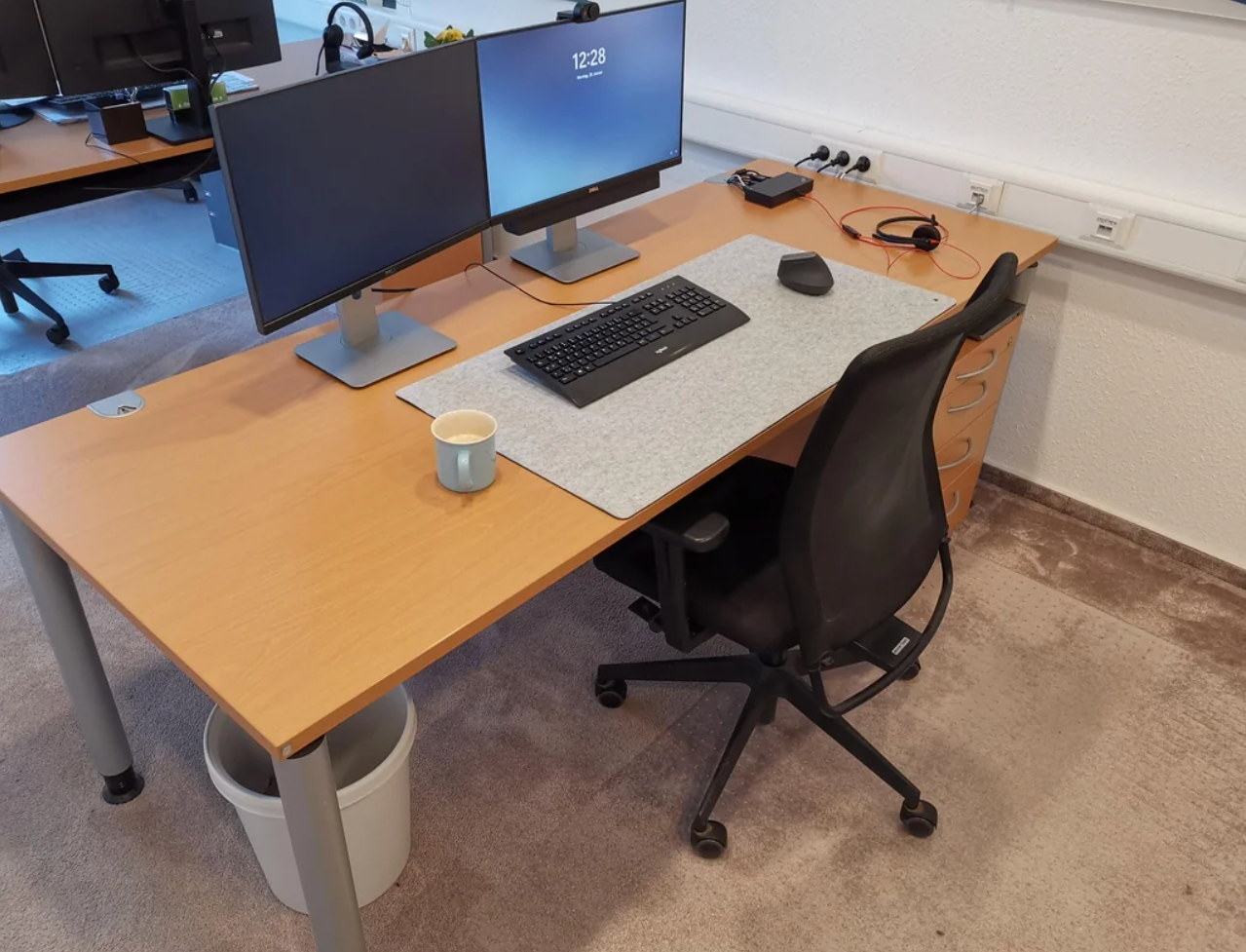 Reddit post showing an office desk setup with dual monitors, keyboard, mouse, and a mug on the desk