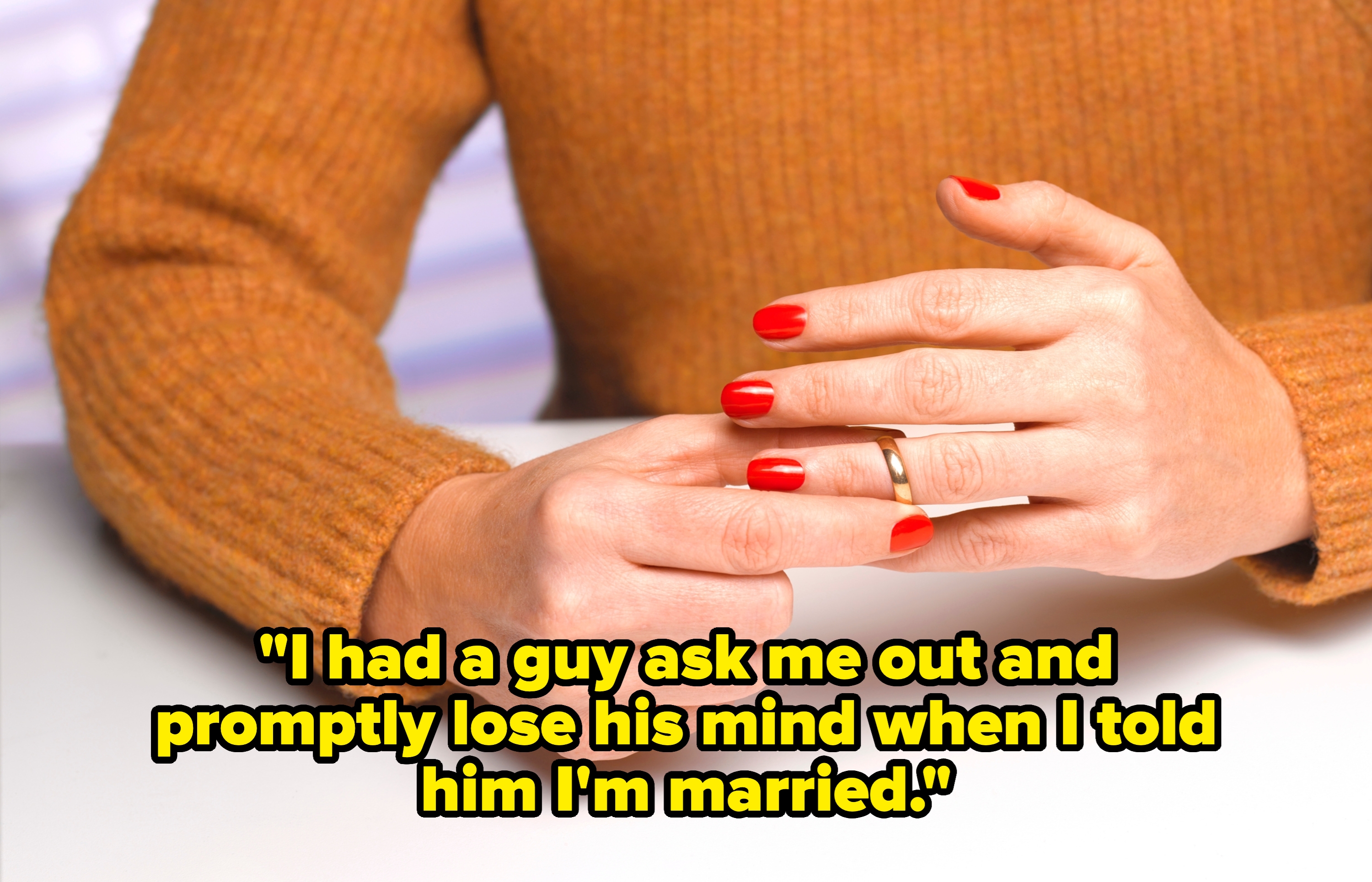 Person wearing a knit sweater and red nail polish removes a gold ring from their finger at a white table