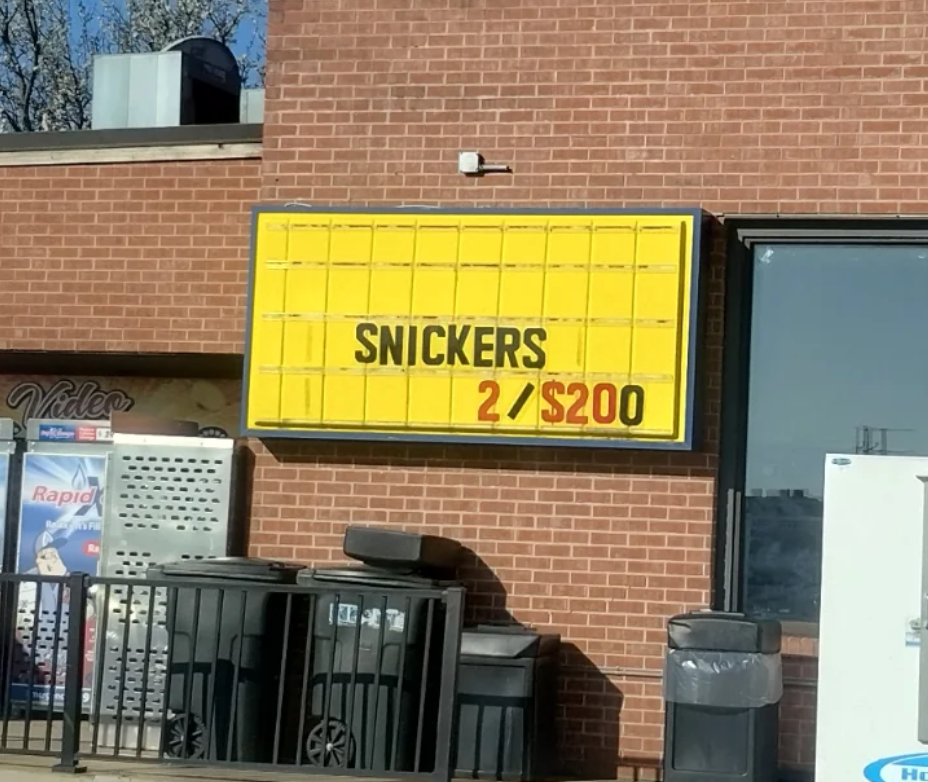 Store sign with error: "Snickers 2/$200."