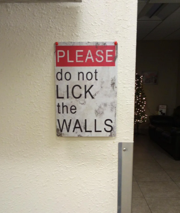 Sign on wall: "Please do not lick the walls."