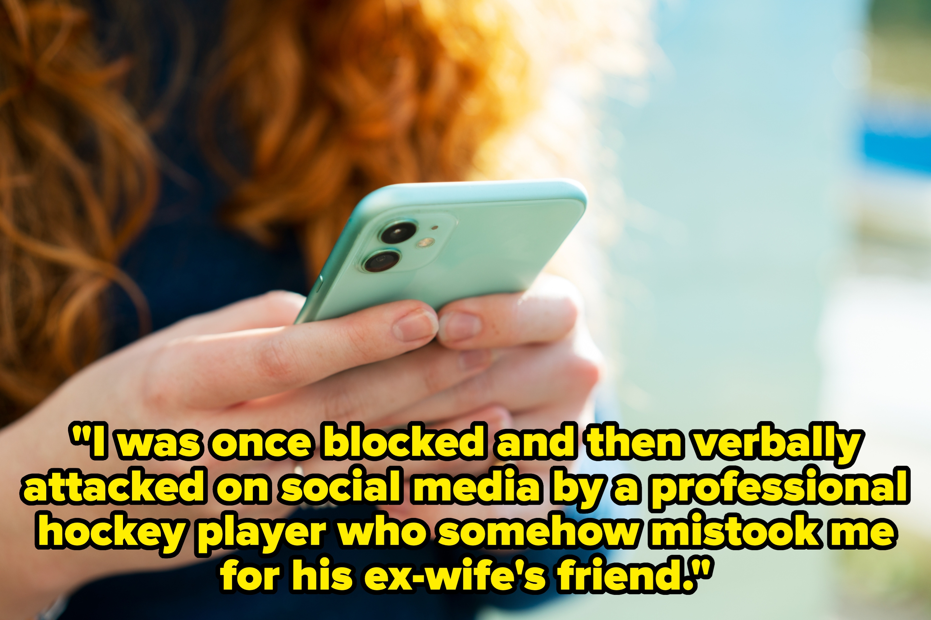 Person using a smartphone, likely texting or browsing, with focus on the hands and device