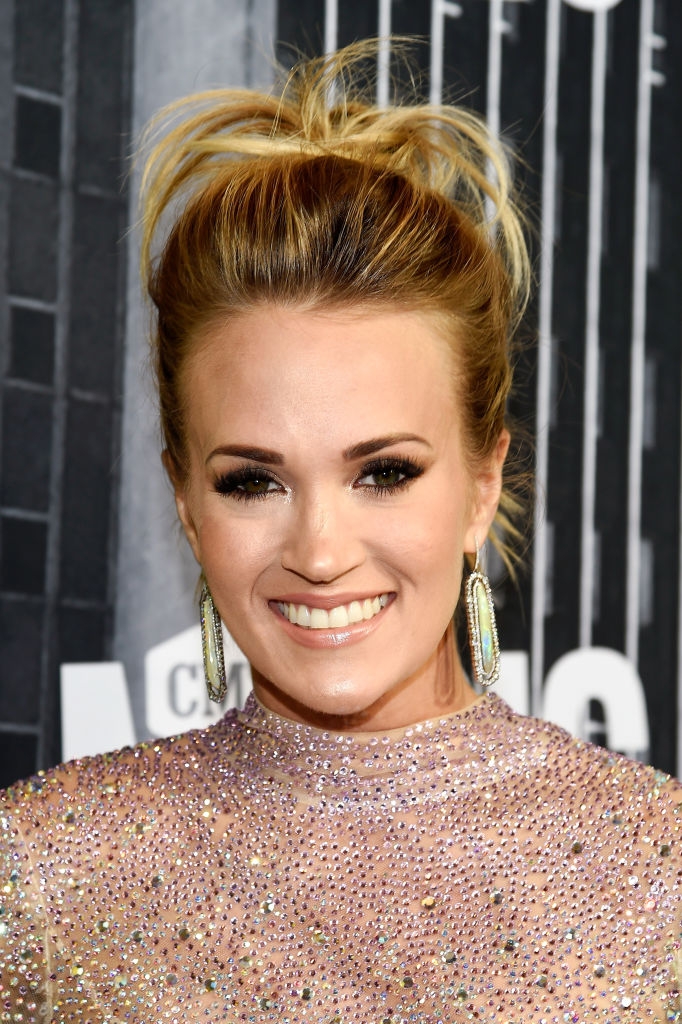 Carrie with light makeup, dark brows, dark eyeshadow, and big lashes