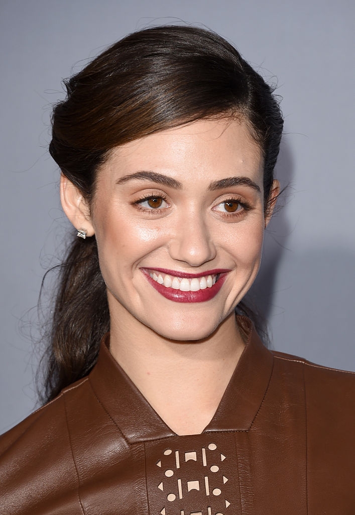 Emmy with warm-toned makeup and a dark lip