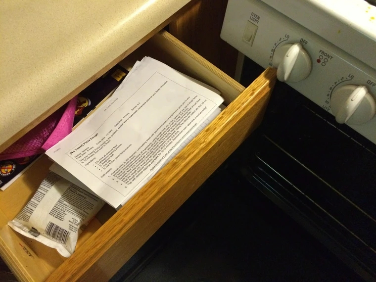 Oven is open, allowing drawer to open, but it hits and turns a knob for the gas range