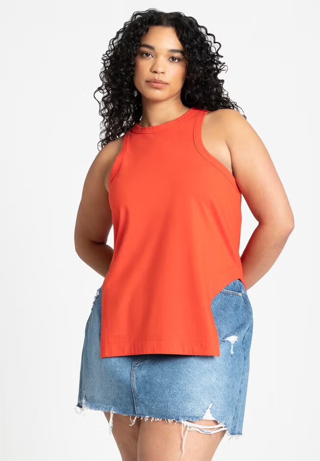 Woman in sleeveless top and denim skirt with frayed hem, posed for a shopping article