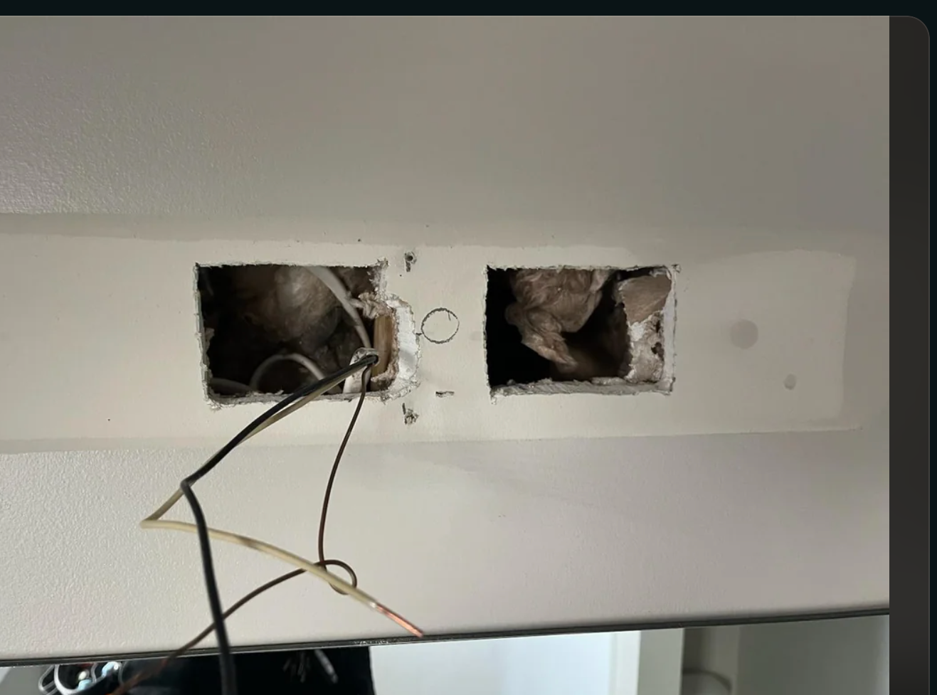 Reddit post showing a user's query about installing a new light fixture in a bathroom, with visible wiring in the wall