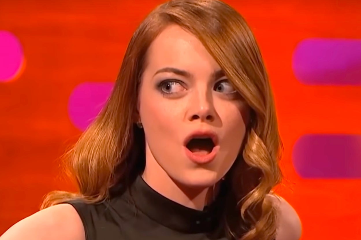 Emma Stone with wavy hair has a surprised expression during a TV show interview