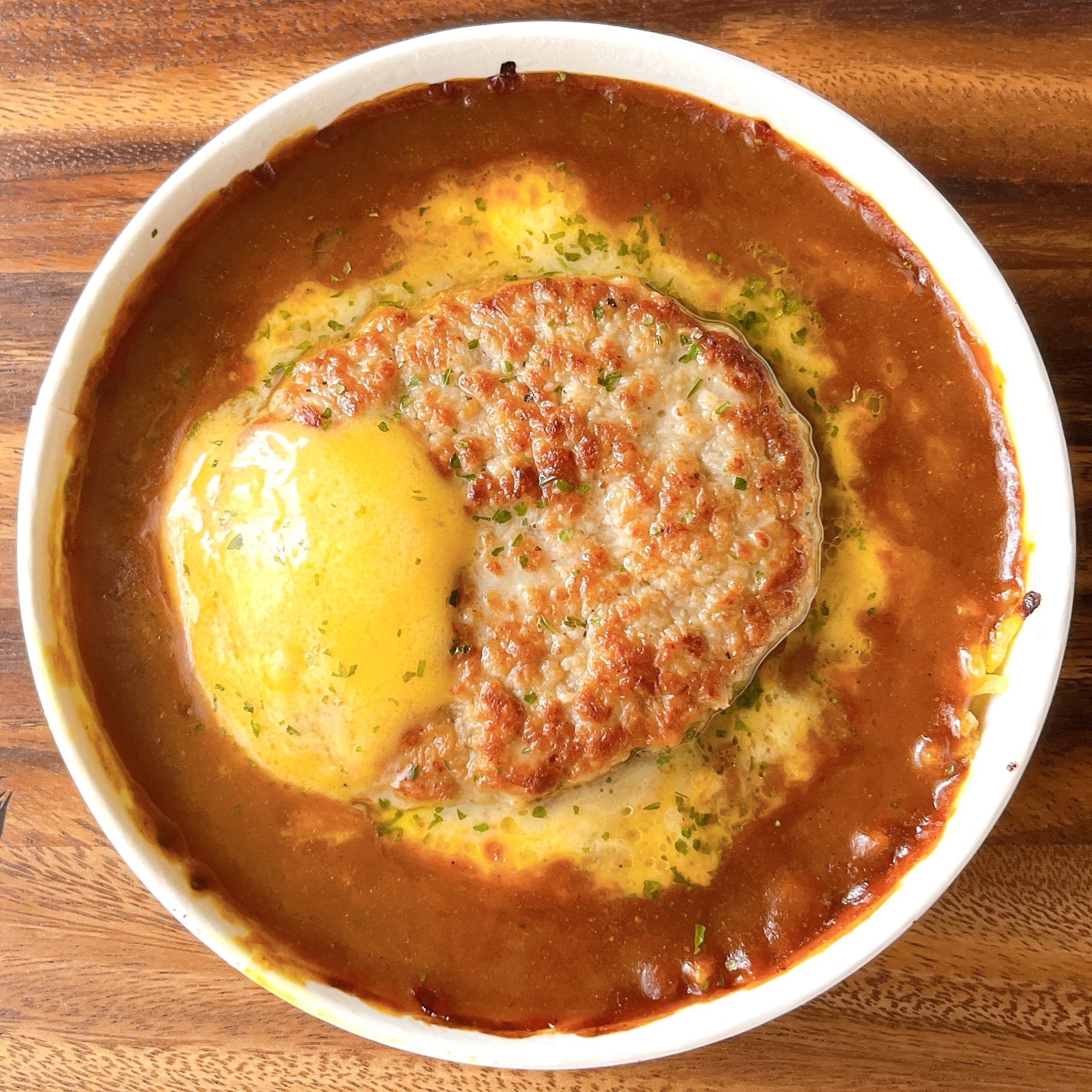 ハンバーグと卵がのったカレーライスの上からの眺め。