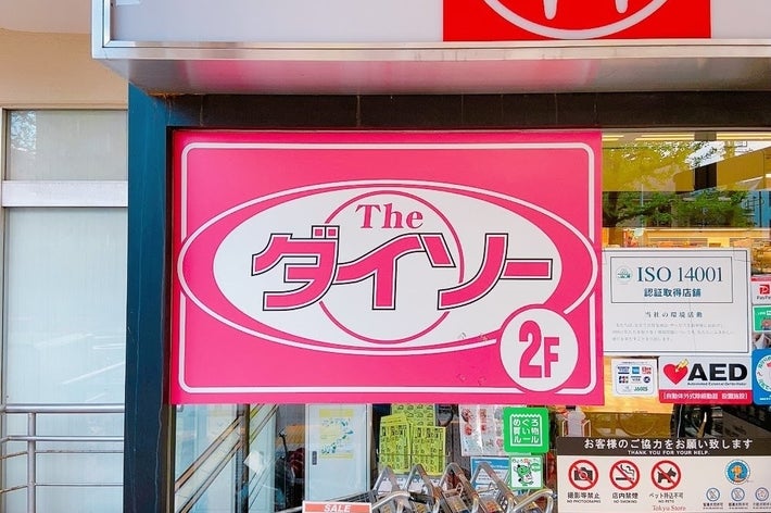 ダイソー店の看板。ISO 14001認証取得、AED設置の案内もあり、入口が見えます。