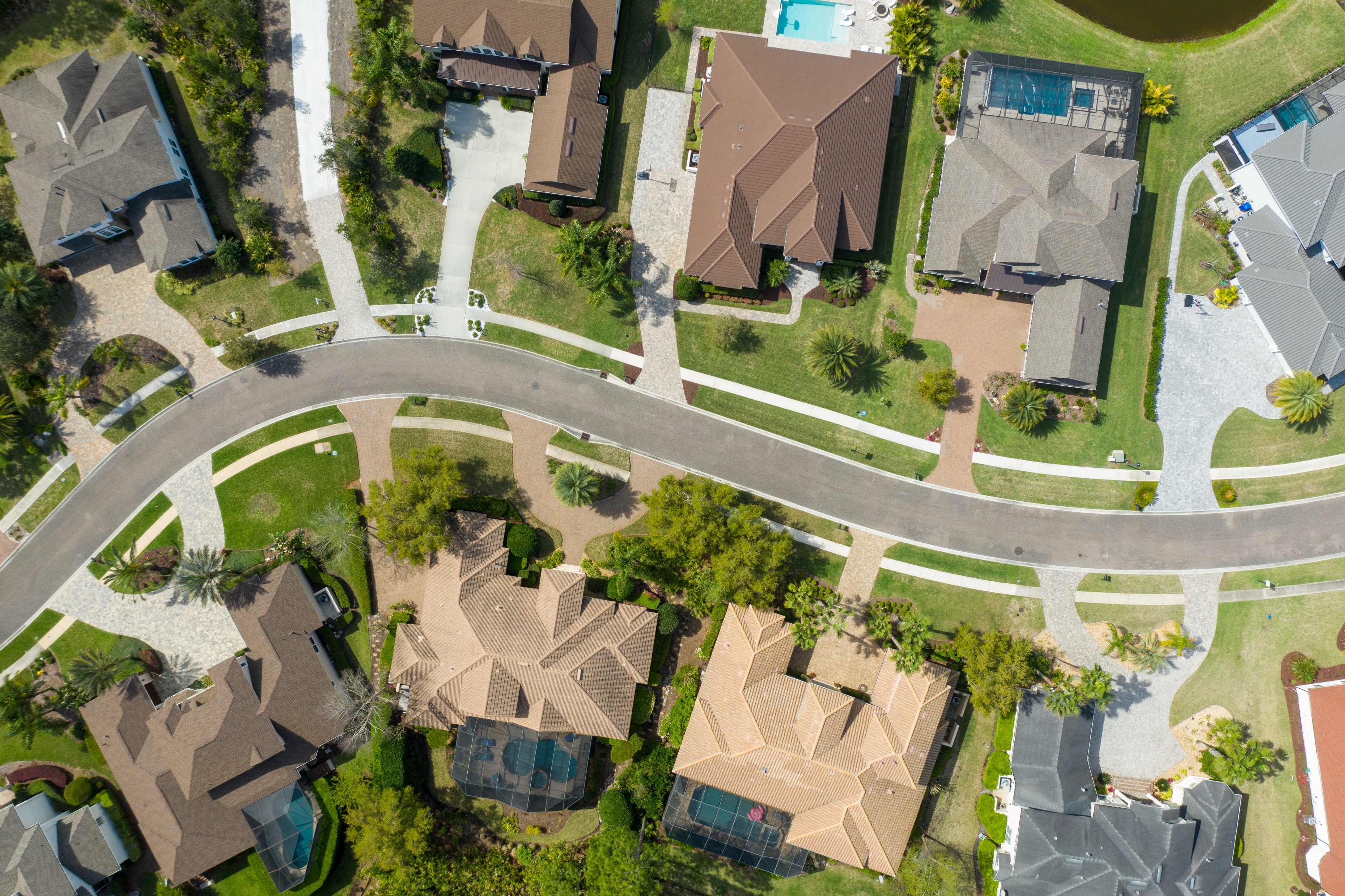Aerial view of a residential neighborhood showcasing several houses with driveways and sidewalks