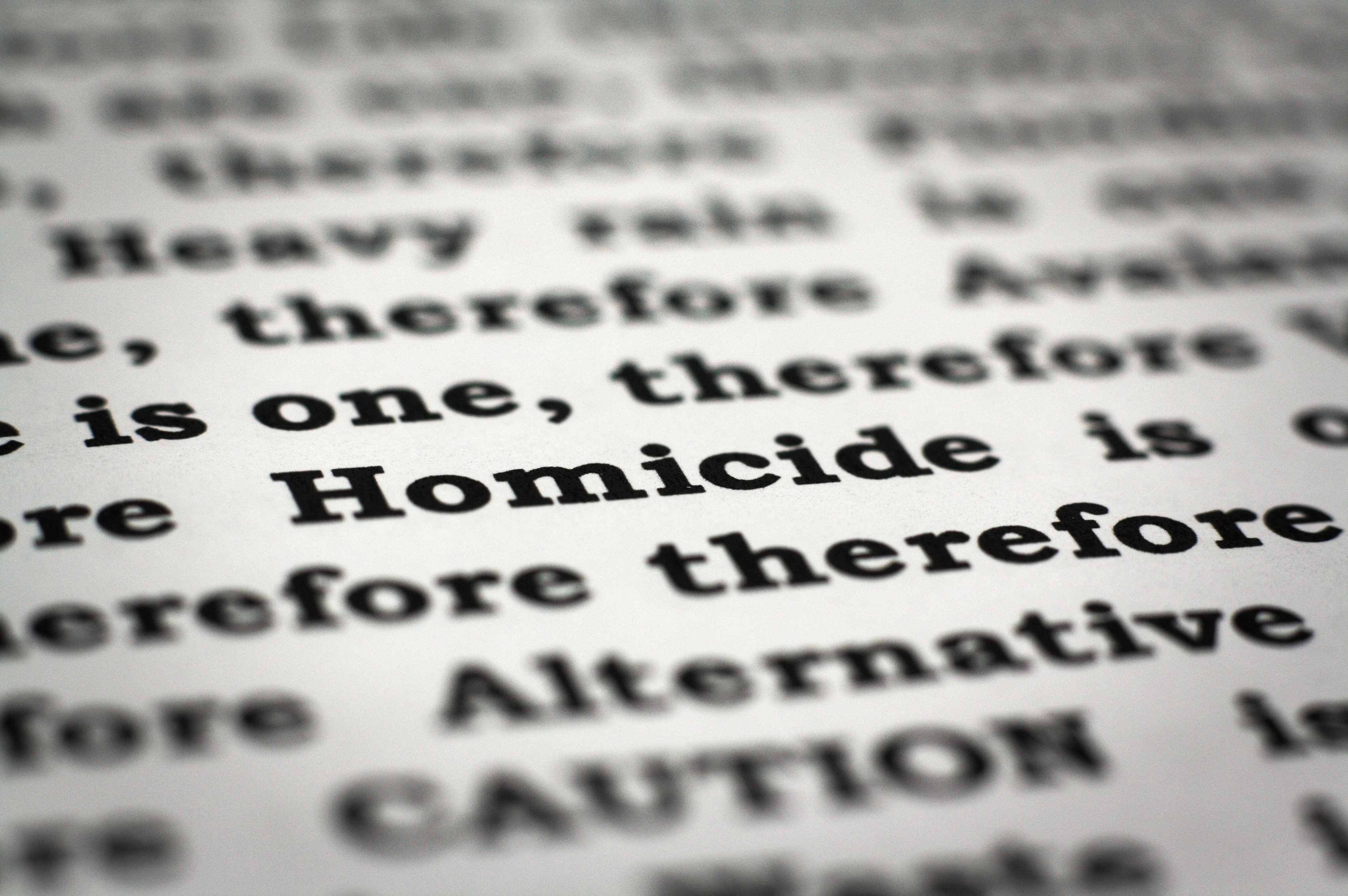 Close-up of text in a book or document. The word "Homicide" is prominently visible among other words