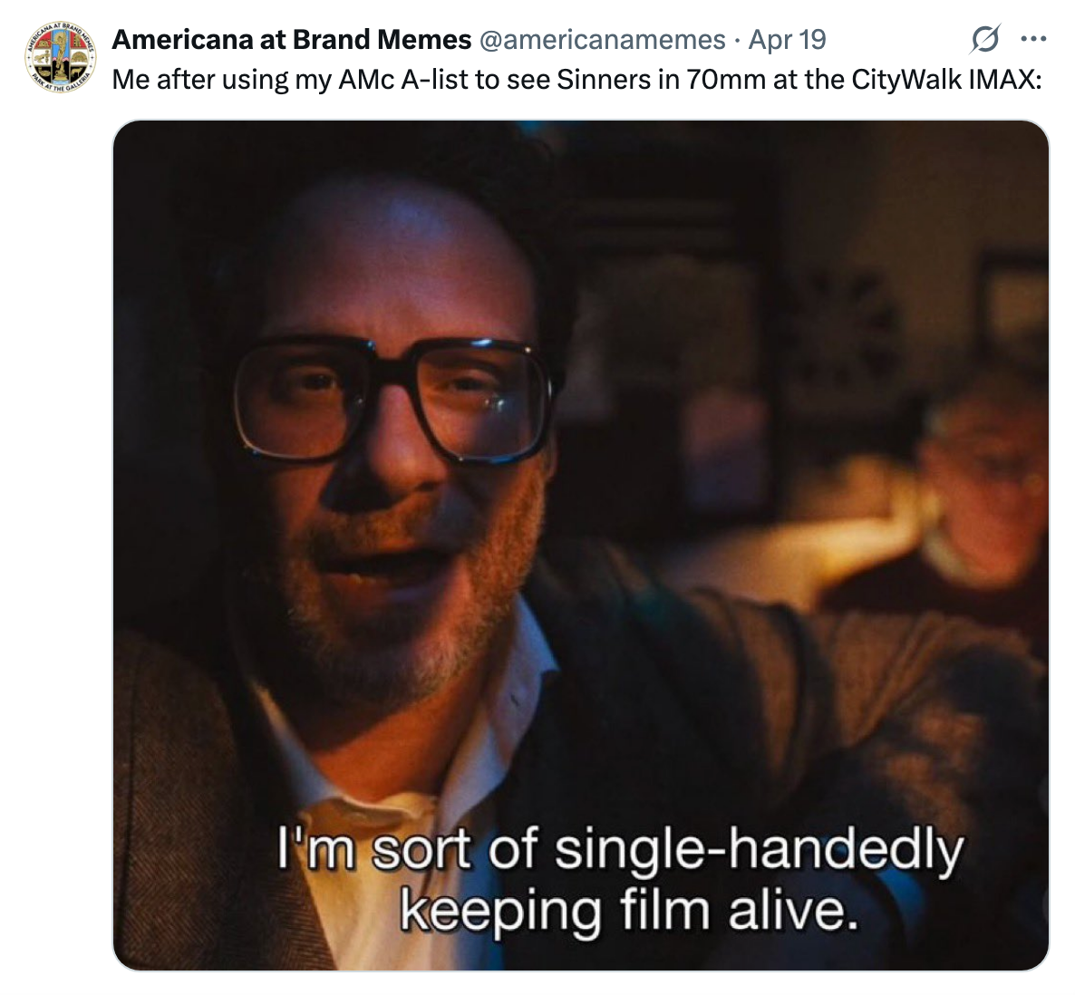 A person in a suit and glasses speaks humorously at an event. Subtitles read: &quot;I'm sort of single-handedly keeping film alive.&quot; The tweet adds a cinema joke