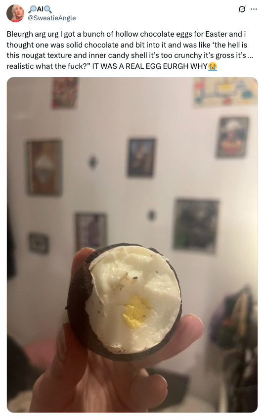 A person holding a chocolate egg with a real egg inside. The text describes their surprise and disgust