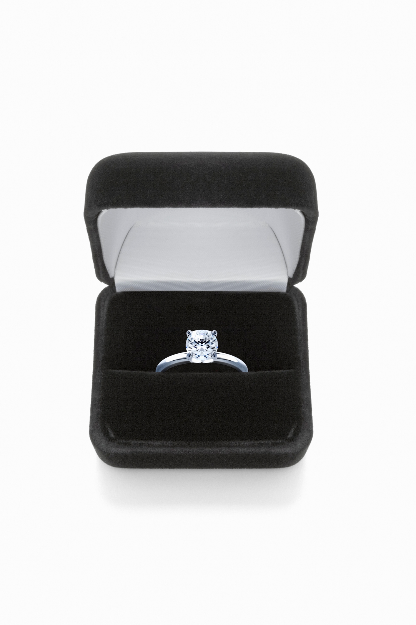Open black velvet ring box with a diamond engagement ring inside