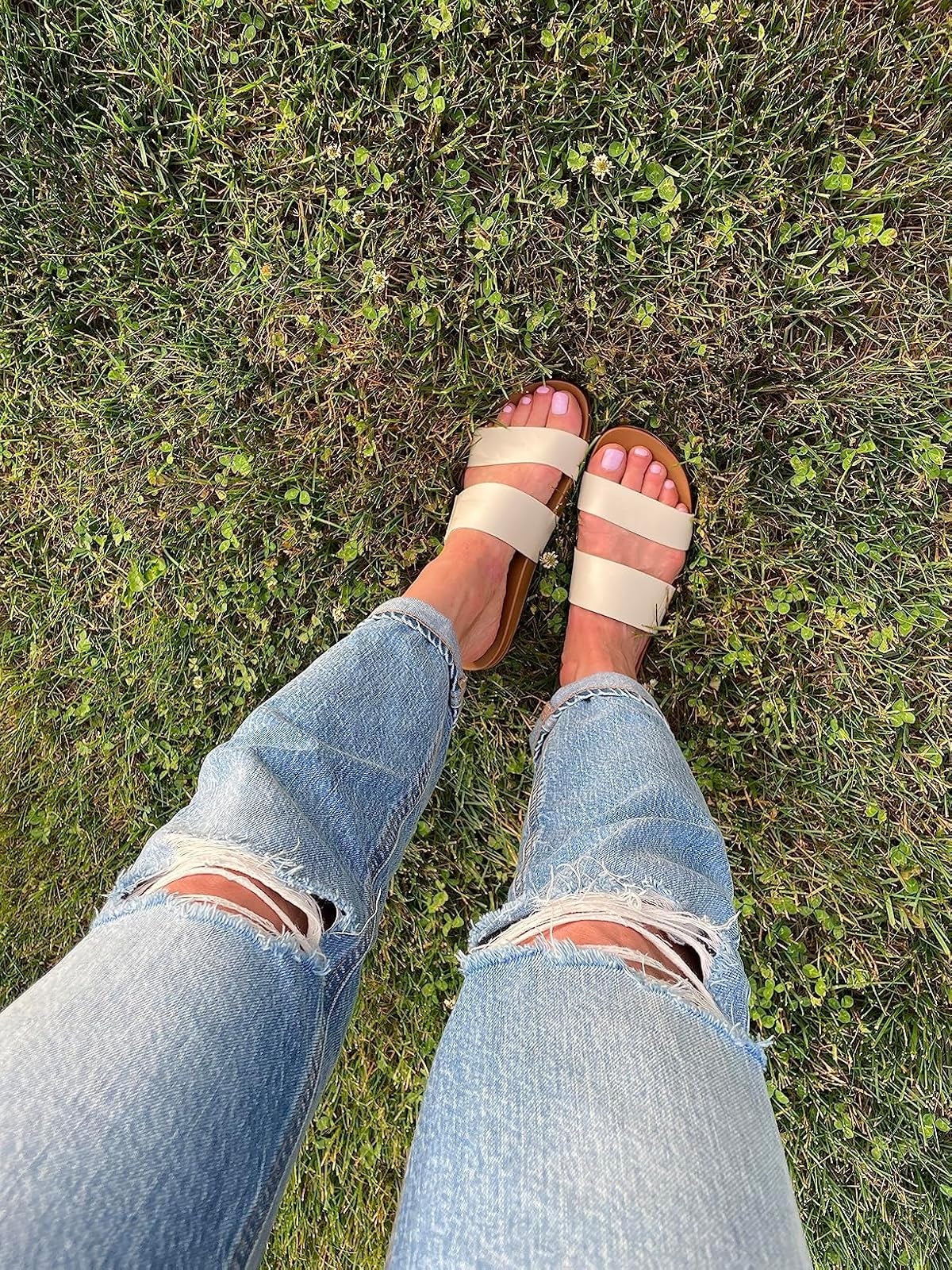 reviewer wearing beige sandals with heavy   straps