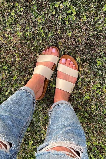 reviewer wearing beige sandals with heavy straps