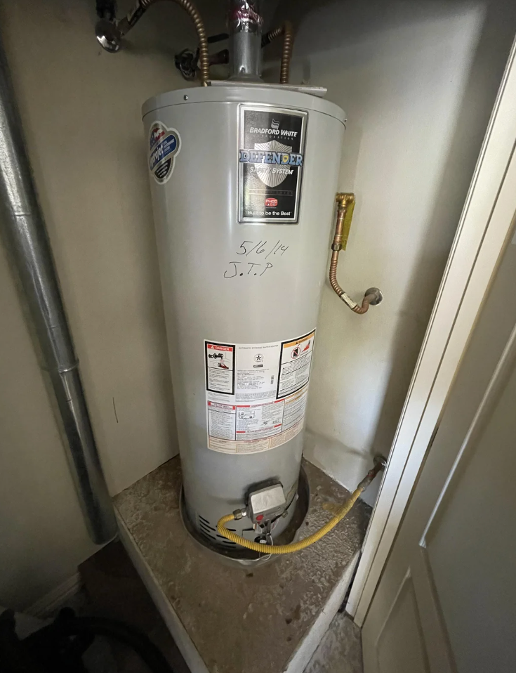 Screenshot of a Reddit post about replacing a hot water heater, with user comments and engagement statistics visible