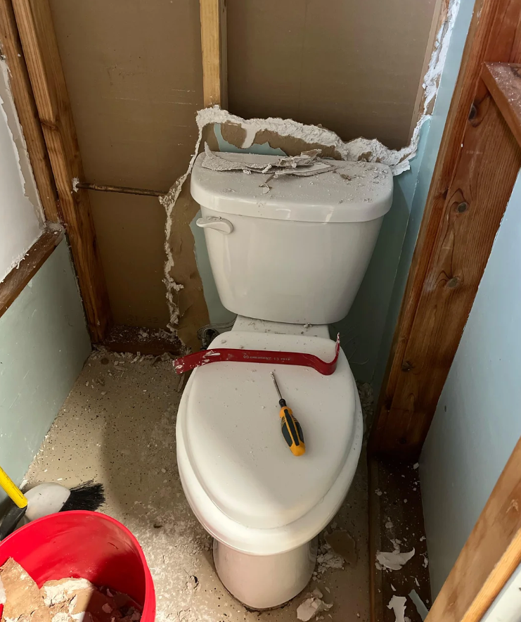 Screenshot of a Reddit post showing a bathroom with a toilet installed awkwardly close to a shower, causing space issues