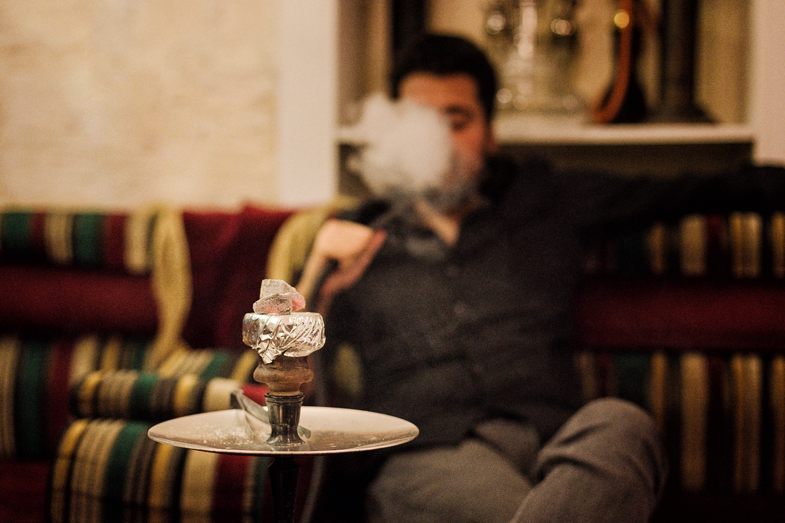 Man smoking hookah by himself