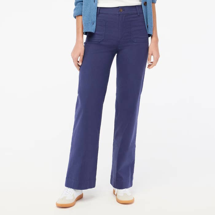 Social media trends Viral content Trending hashtags Social media updates Trending memes and videos Person wearing wide-leg trousers with white sneakers, shot from the torso down