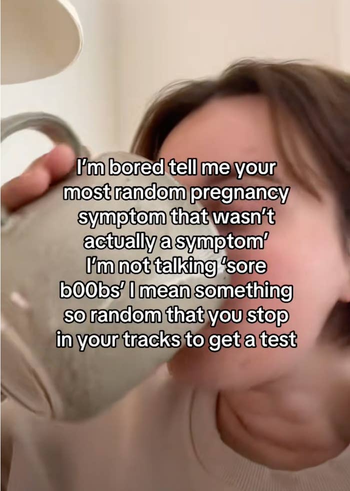 A person drinks from a mug with overlaid text asking for random pregnancy symptoms that prompted them to take a test, excluding typical ones
