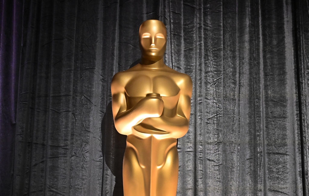 Oscar statue in front of a curtain backdrop at an awards event
