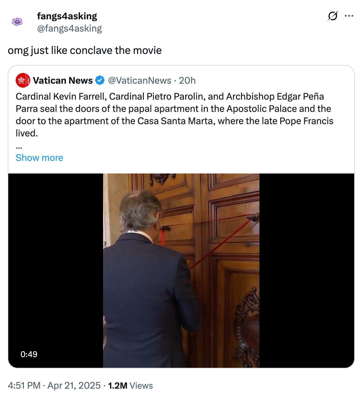 Man in formal suit ties red ribbon on large wooden door, as onlookers observe solemnly. Image relates to an official ceremony or event