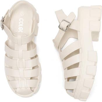 Chunky achromatic sandal-shoes with straps and a buckle, featuring a heavy sole design