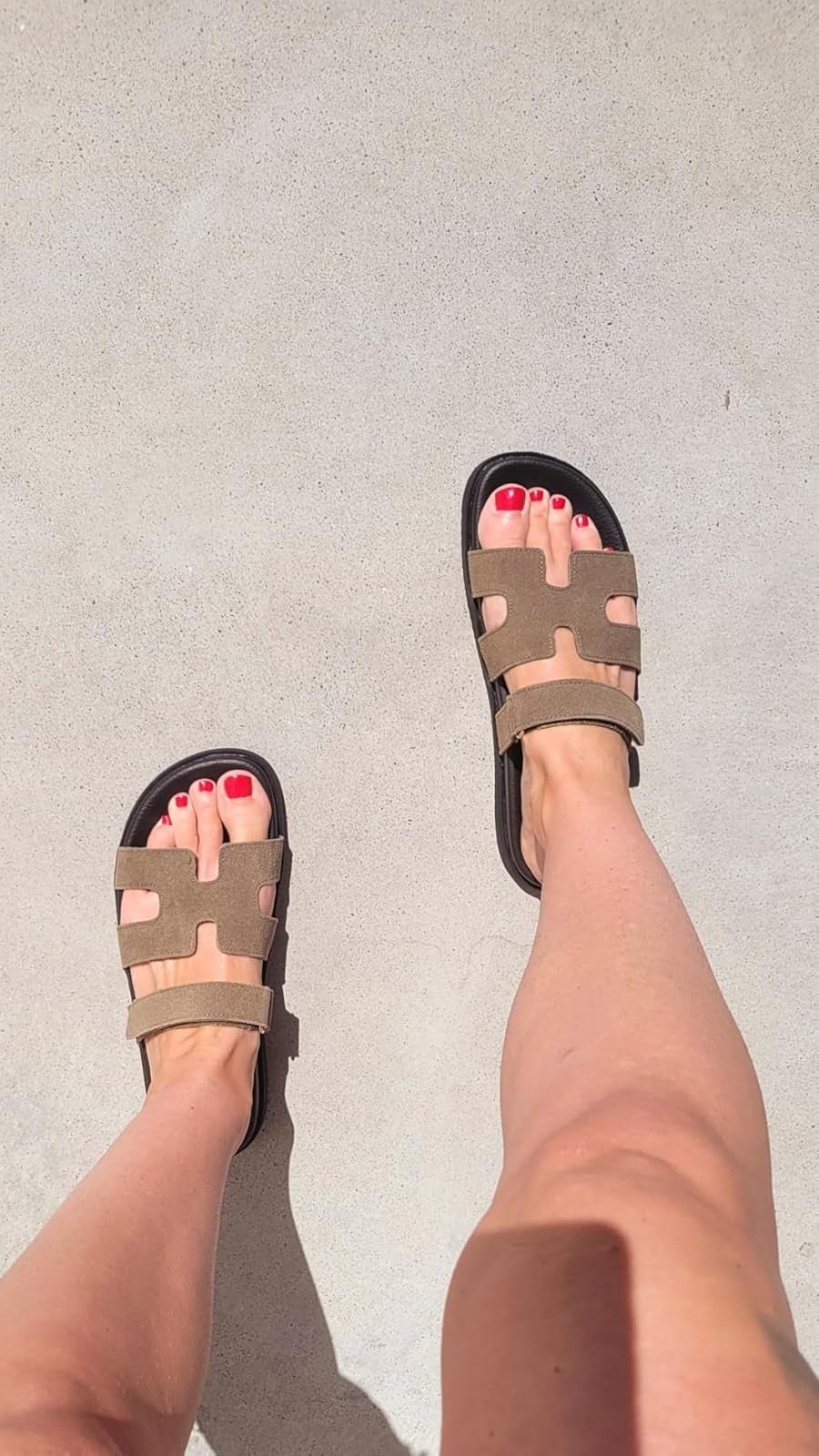 reviewer wearing stylish open-toe sandals with a geometric cut-out design