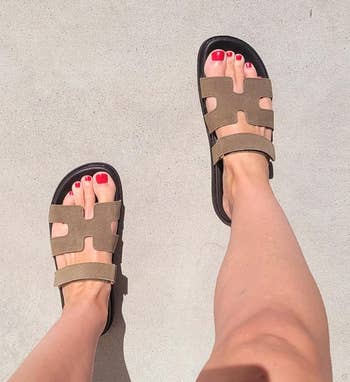 reviewer wearing stylish open-toe sandals with a geometric cut-out design