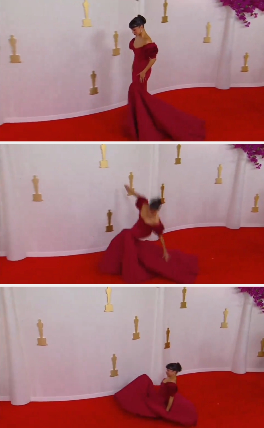 Person in elegant gown stumbles and sits on red carpet at a formal event backdrop