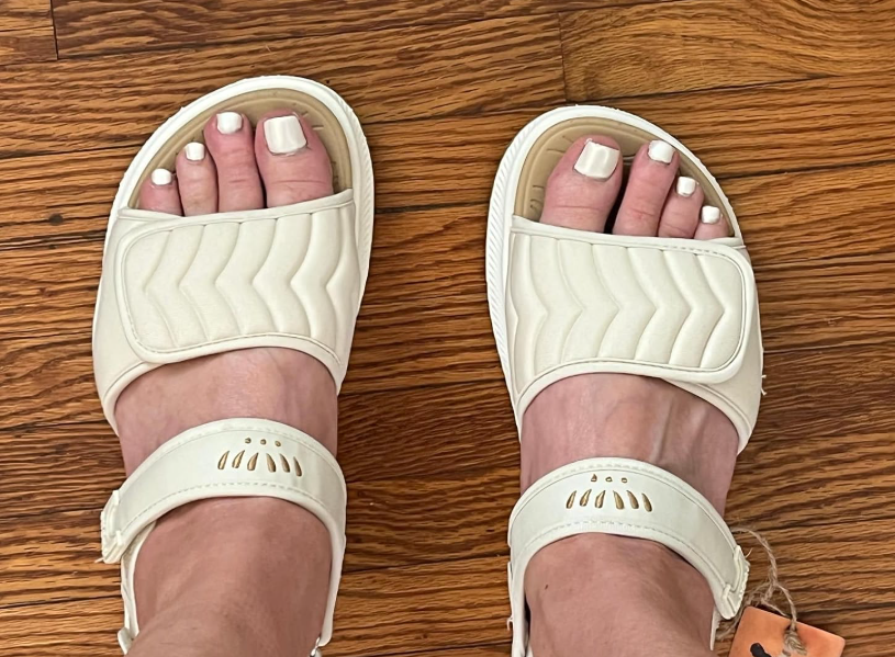 reviewer wearing pick  sandals with Velcro straps and quilted texture